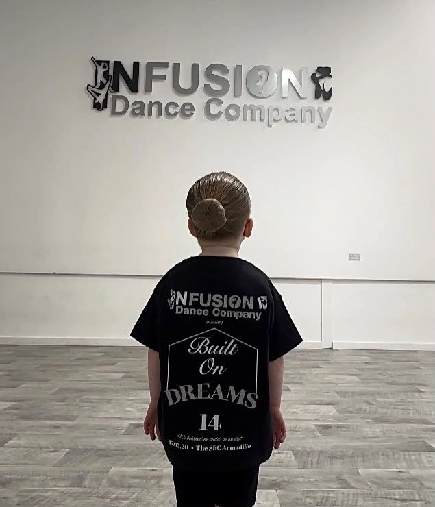 Young Infusion dancer wearing a Built On Dreams t-shirt